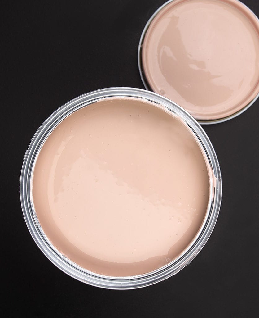 Get plastered dusky pink paint tin on dark background