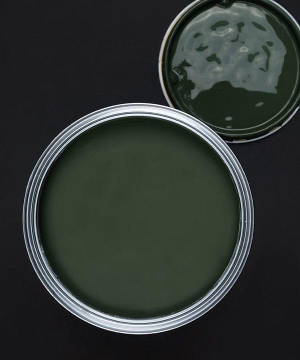 Spruce things up dark green paint tin on dark background