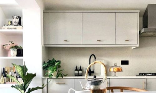 gold t-bar skyscraper handles on white kitchen cupboards in a neutral kitchen-diner
