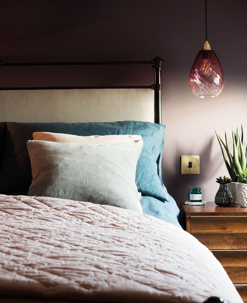 smoked gold and black single rocker switch on a soft pink wall in a bedroom