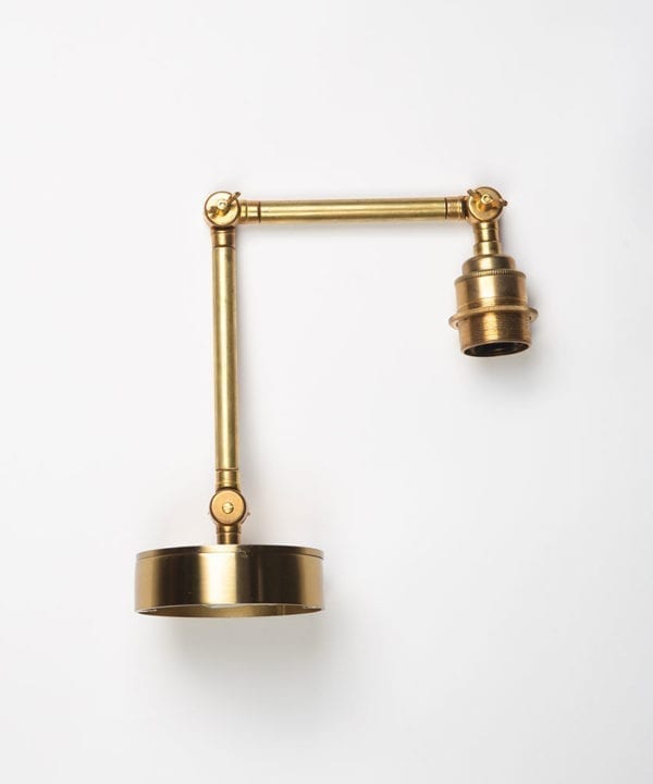 fender brass wall light on white background
