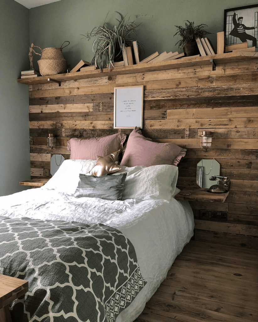 wooden panelled headboard in sage green bedroom with simon bulkhead lights either side of the bed