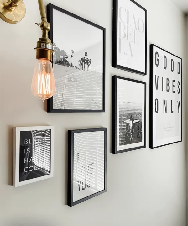 Brass Fender wall light next to a gallery of prints.