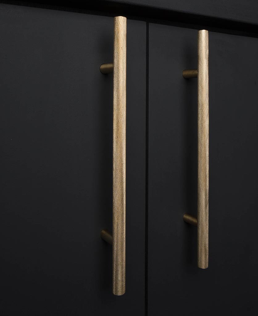 brass skyscraper cupboard handles on black cupboard