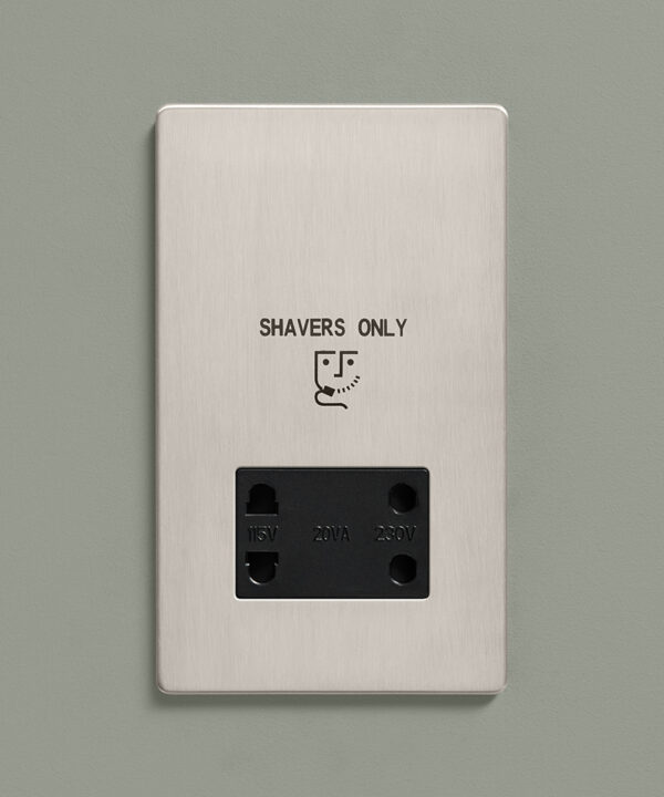 silver shaver socket on a sage green wall