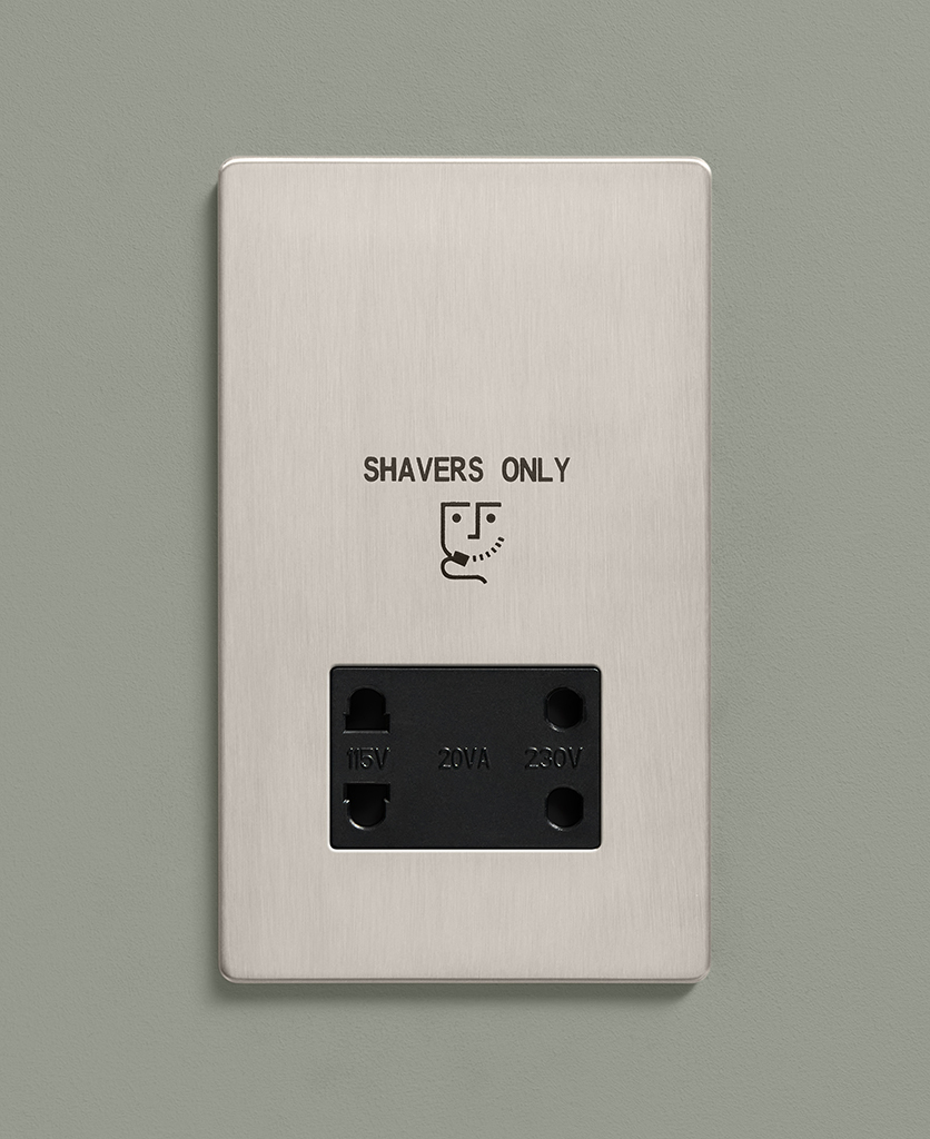 silver shaver socket on a sage green wall