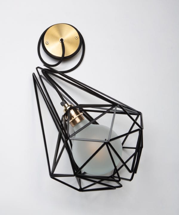 large black cage pendant light with frosted light bulb, black fabric cable, gold bulb holder and gold ceiling rose against white background