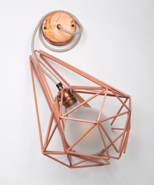 large pink metal cage pendant light with frosted bulb, linen fabric cable and tarnished copper bulb holder and ceiling rose against white background