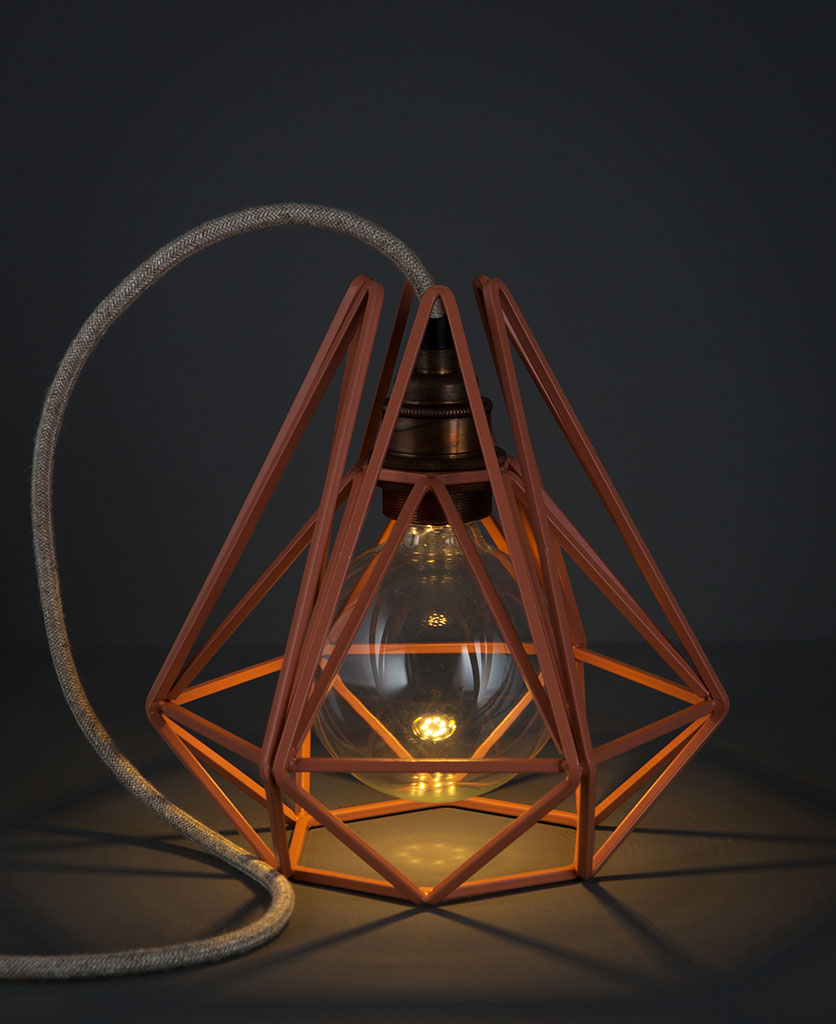 pink chai cage table lamp against black background