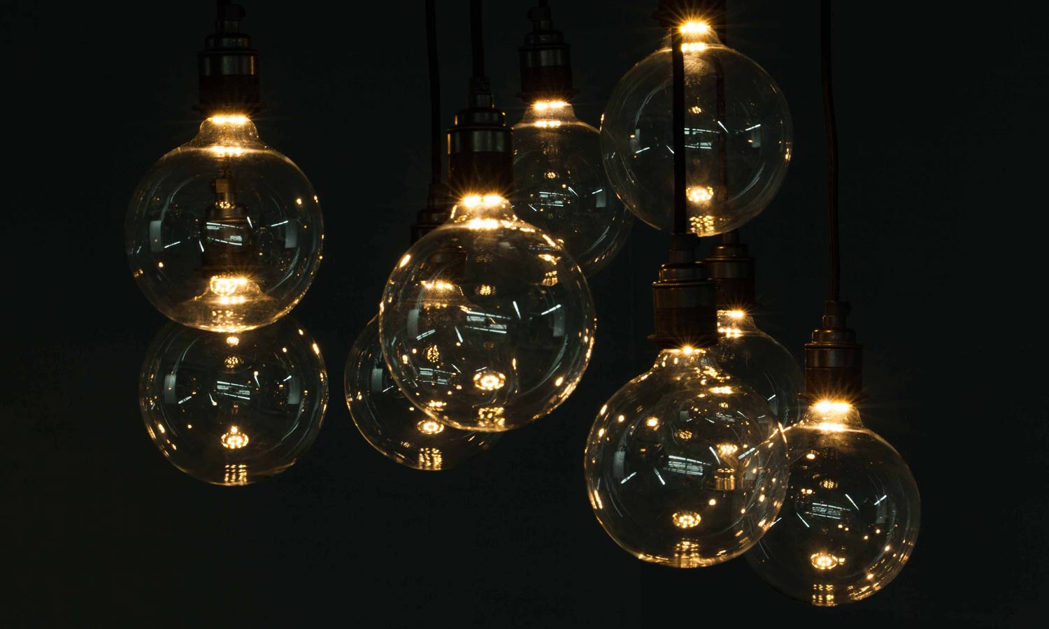 cluster of concealed filament globe bulbs against black background