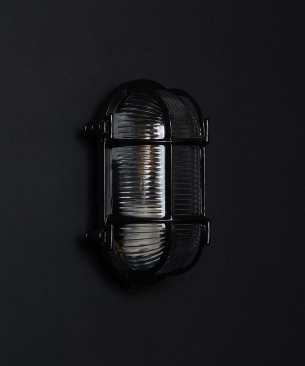 steve unlit black bulkhead light with wingnuts against black background