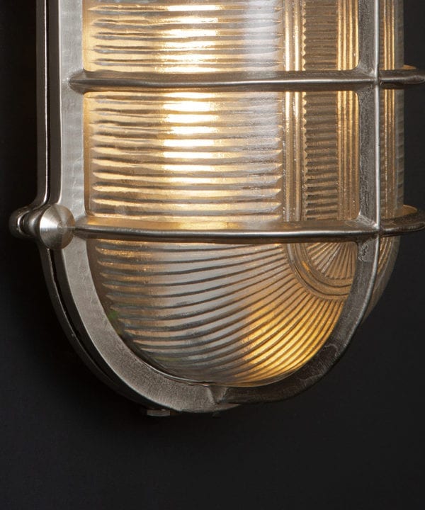 close up of lit silver big Steve on black background