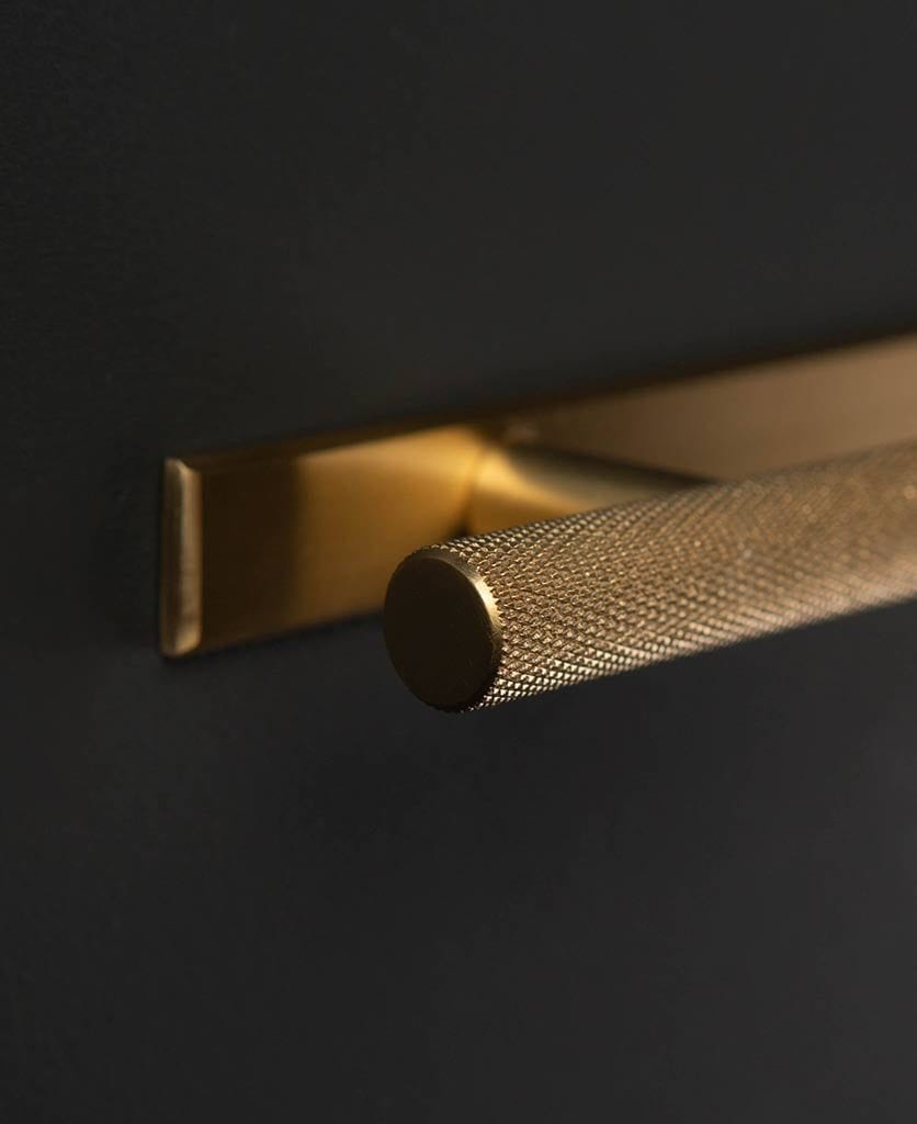 Brass skyscraper knurled handle with plate on black drawer