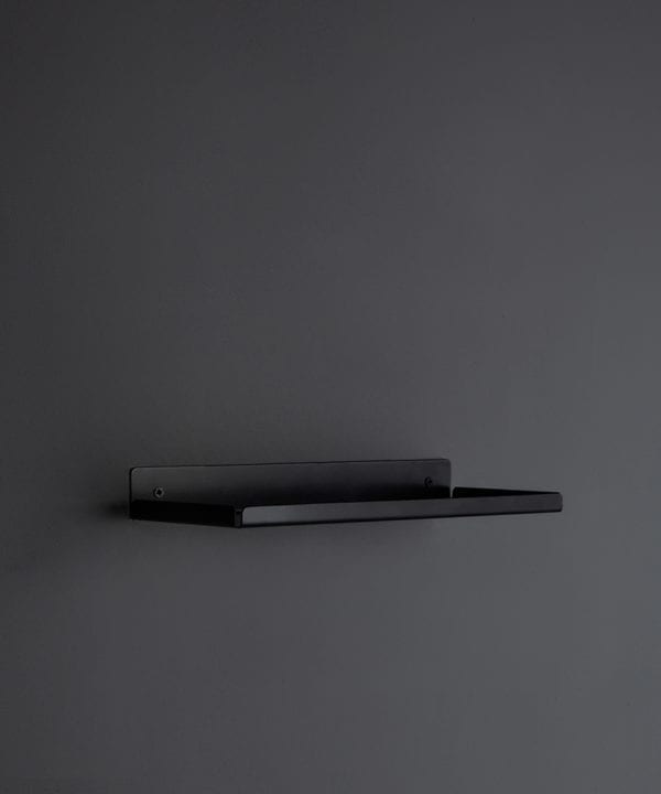 assam black metal wall shelf on a dark grey wall