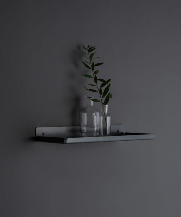 earl grey shelf with glass vases on a dark grey wall