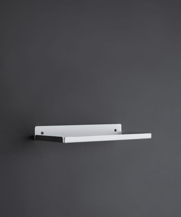 white metal wall shelf on a dark grey wall