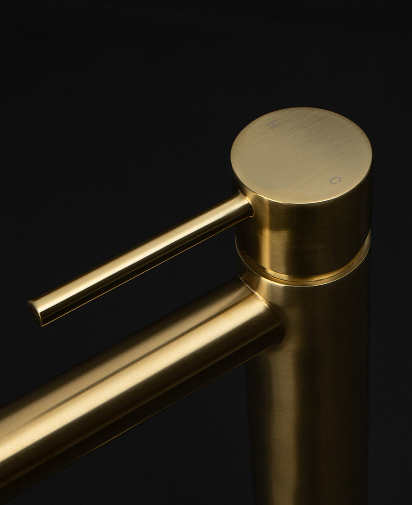 gold inga tap close up of handle hot and cold on black background