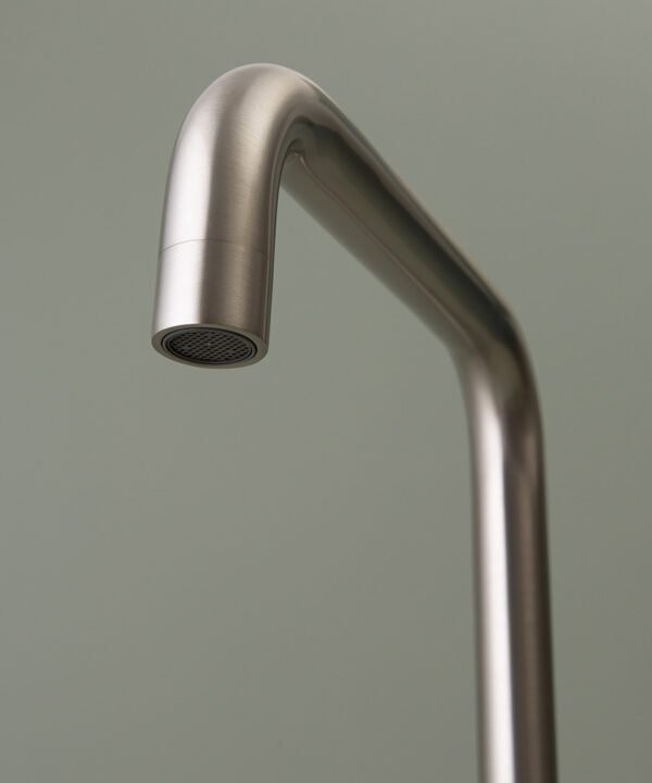 silver kintampo tap spout close up on grey-green background