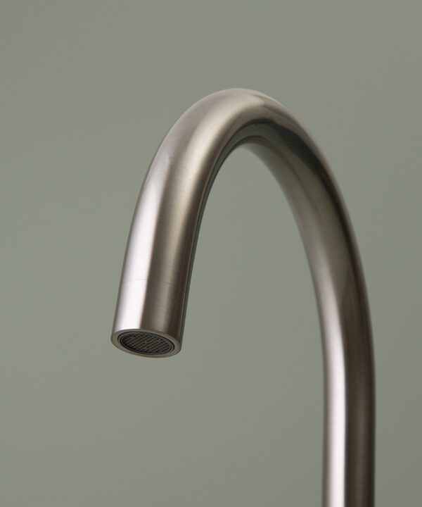 silver tinkisso tap spout close up on grey-green background