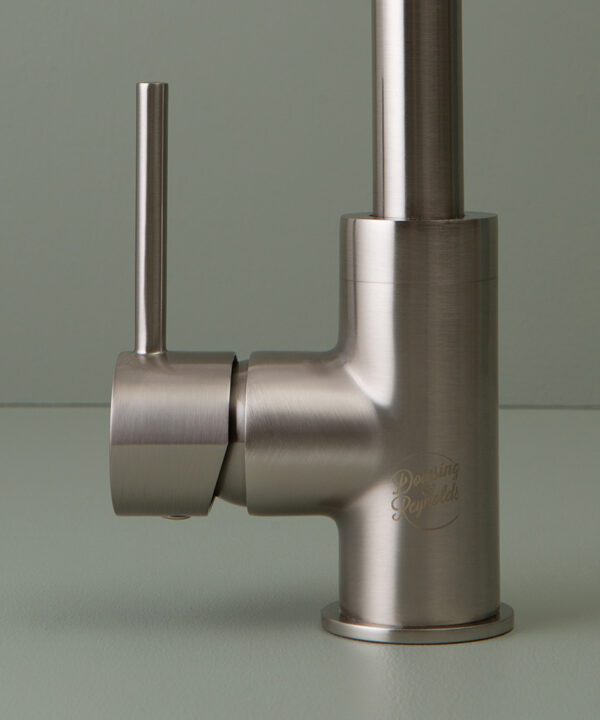 silver tinkisso tap logo an handle close up on grey-green background