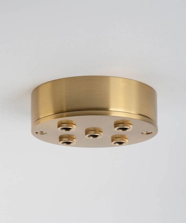 five point raw brass ceiling rose against white background