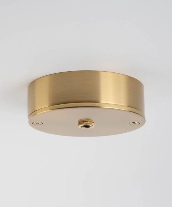 one point raw brass ceiling rose against white background
