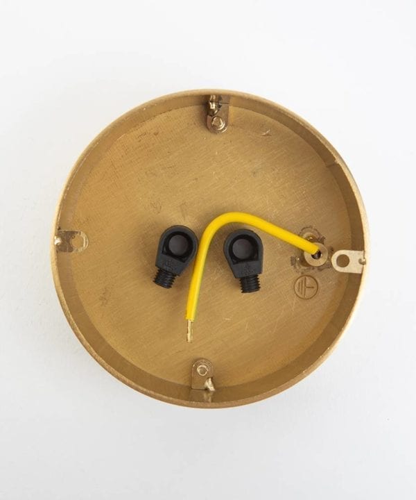 reverse view of two point raw brass ceiling rose against white background