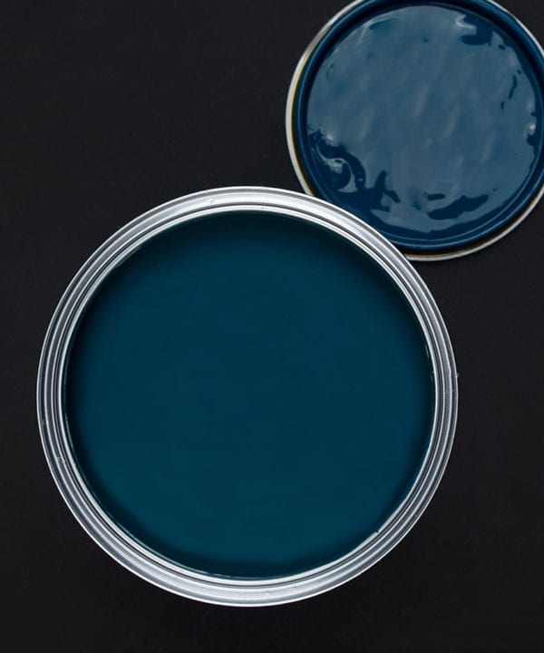 In deep water rich blue paint tin on dark background