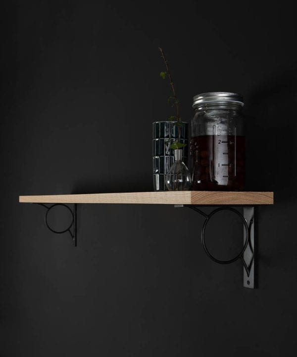 small mae oak shelf and brackets on black background