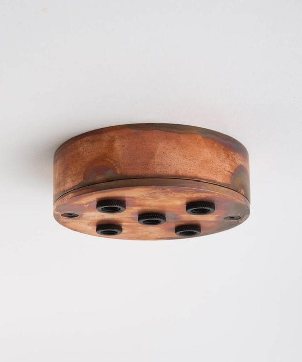 tarnished copper five point ceiling rose against white background
