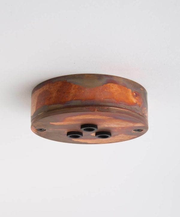 tarnished copper three point ceiling rose against white background