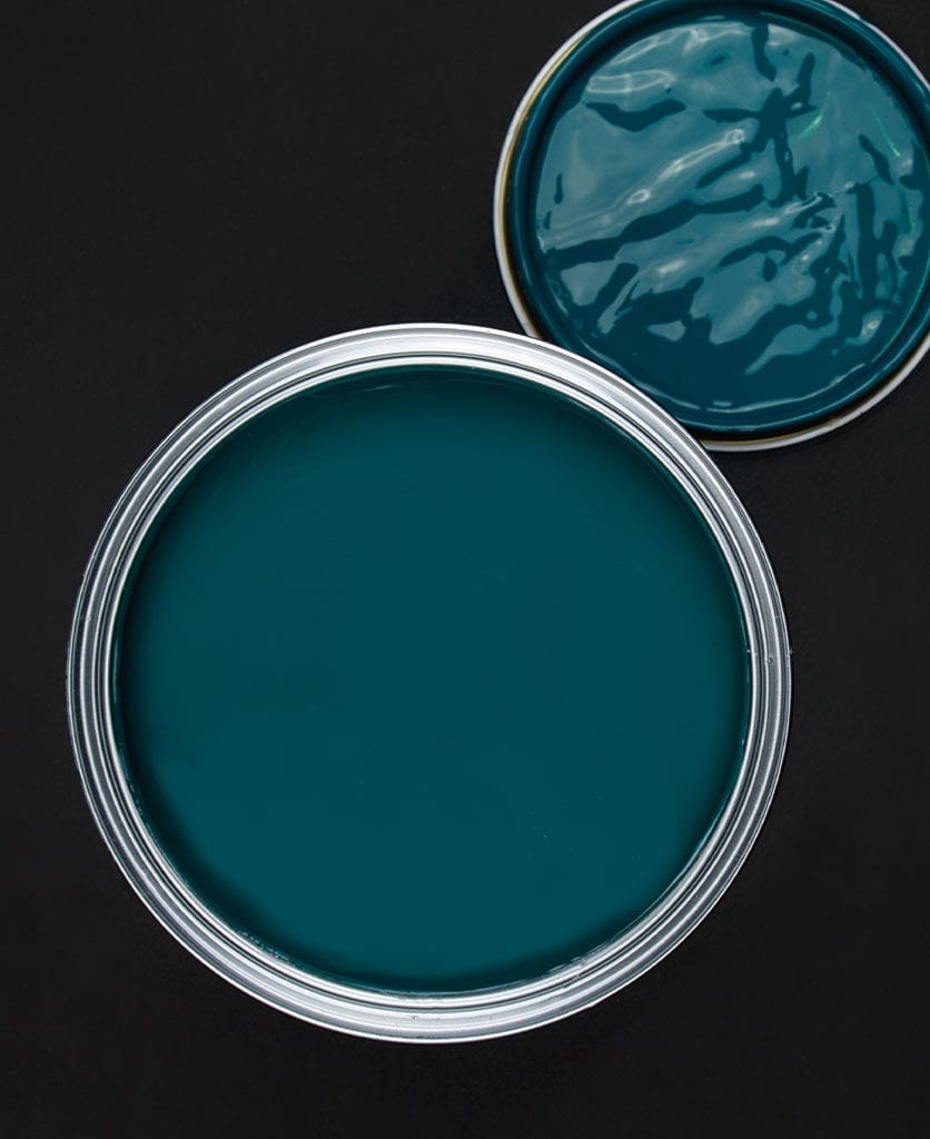 Teal the show blue green paint tin on dark background