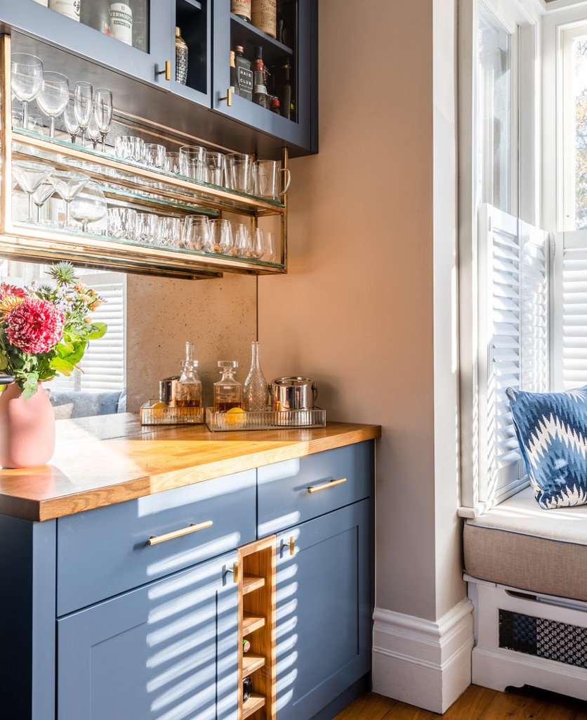 gold hive handle on blue kitchen units