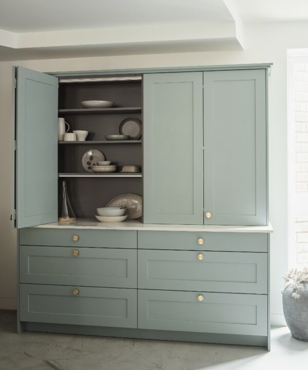 sage green kitchen unit with gold knobs