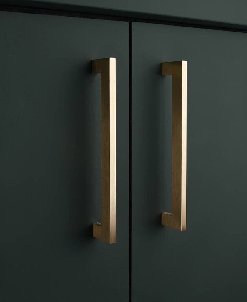 Brass gamma kitchen cupboard handles on dark grey cupboard