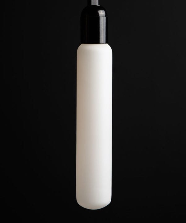 luna unlit tube light bulbs with black bakelite bulb holder against black wall