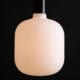 pandora lit square light bulbs suspended from black bakelite bulbholder against black background