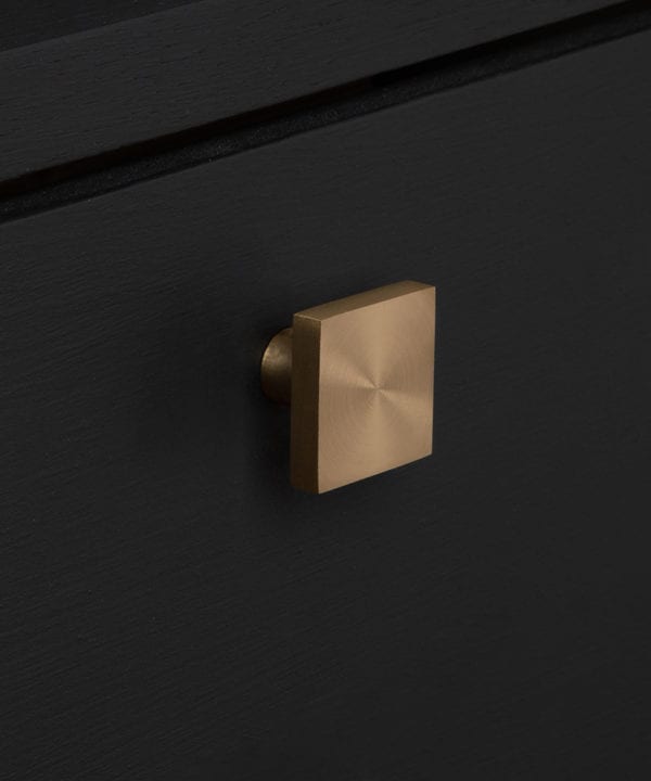 expressionist knob gold on black drawer