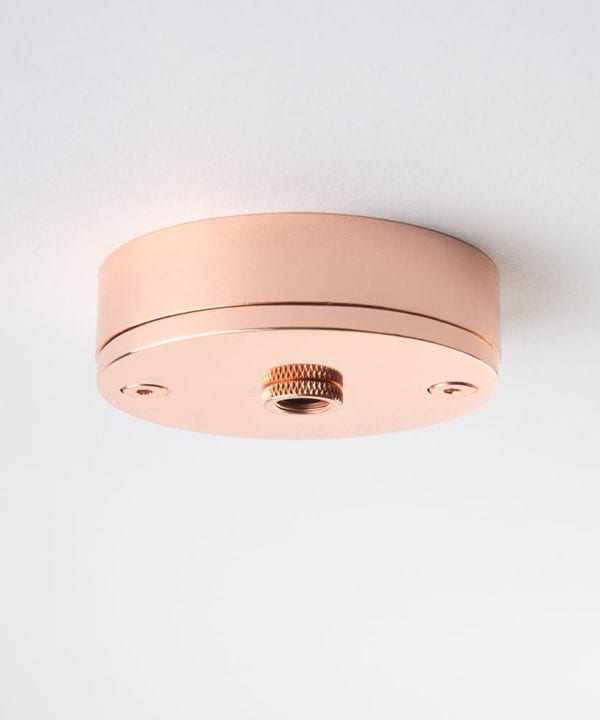 small copper ceiling rose against white background