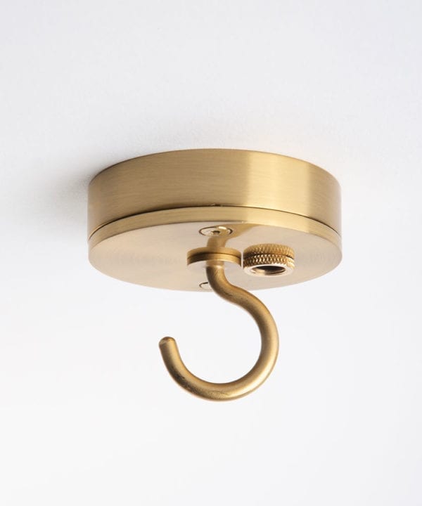 Small gold ceiling rose with c shaped hook against white background