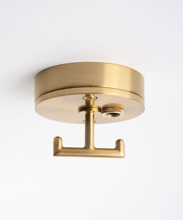 raw brass ceiling rose with t shaped hook against white background