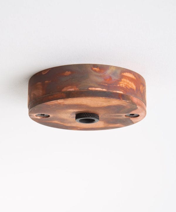 tarnished copper small ceiling roses against white background