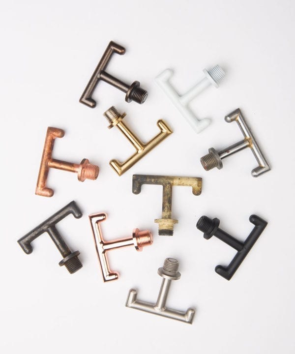 metal t shaped hooks against wjite background