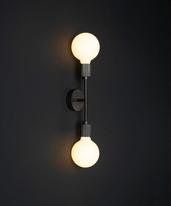 belgravia antique black lit LED wall light against black wall