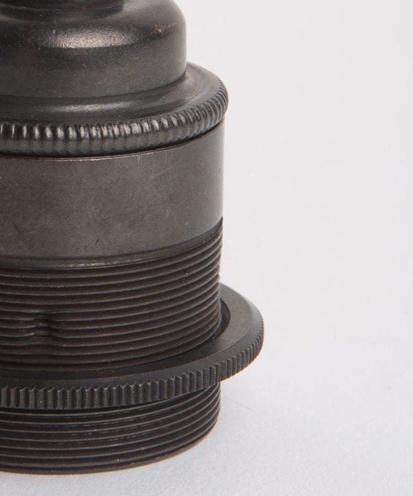 closeup of antique black threaded e27 light bulb holder against white background