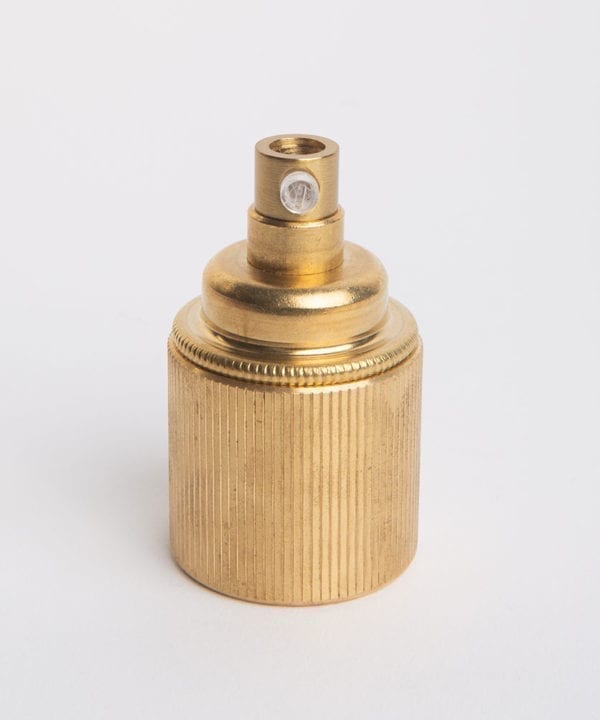 e27 raw brass lamp holderwith ribbed detail against white background