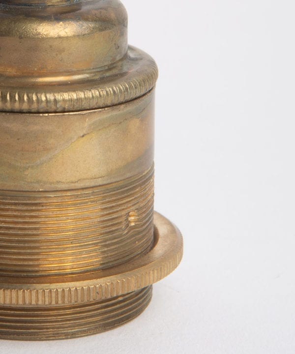 closeup of smoked gold threaded lamp holder against white background