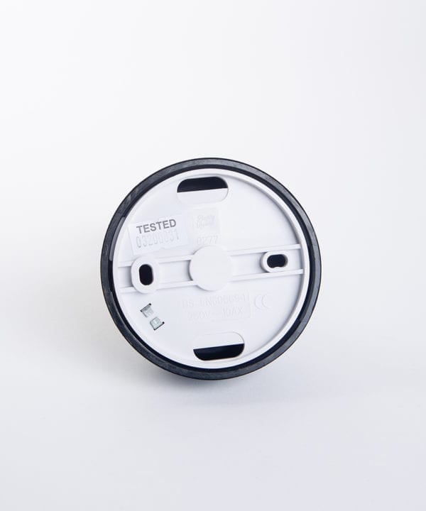 back view of pull cord switch against white background