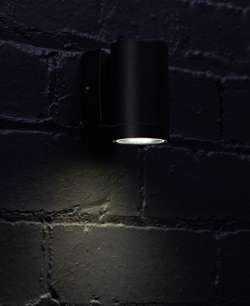 capella black garden light against black brick wall