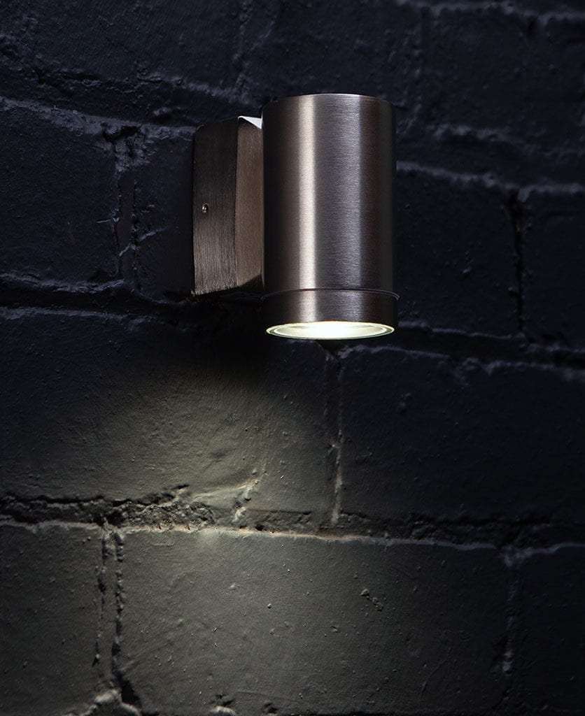 capella silver garden light against black brick wall